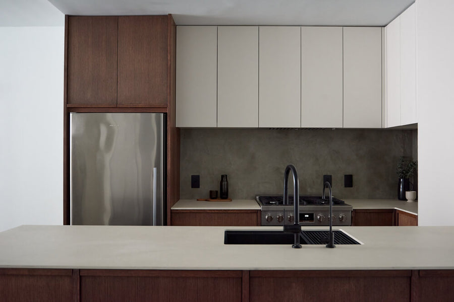 A full view of a modern kitchen with both white and dark brown kitchen cabinets. 