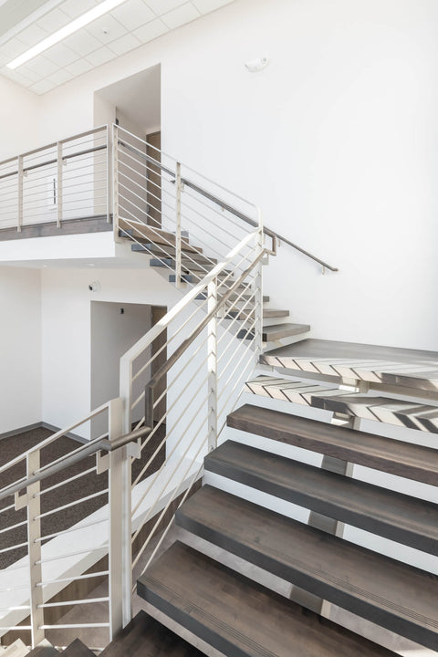Custom-fabricated staircase with maple treads and handrails finished with Rubio Monocoat products for a grey look.