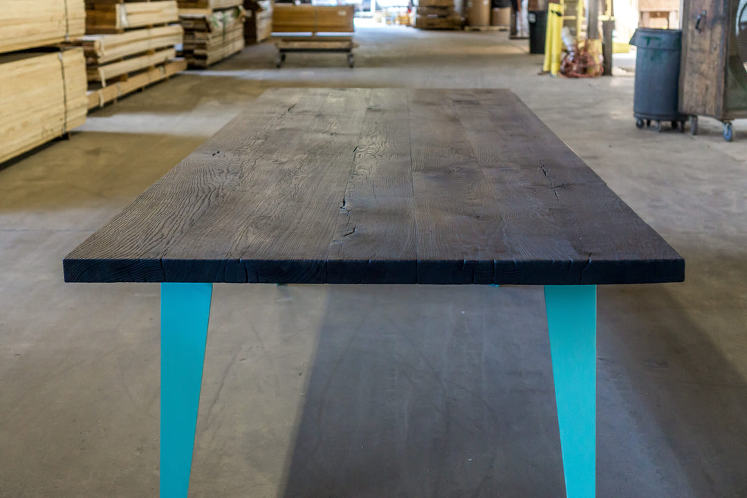 Charred oak table with blue metal legs finished with Rubio Monocoat Oil Plus 2C hardwax oil wood stain and finish.