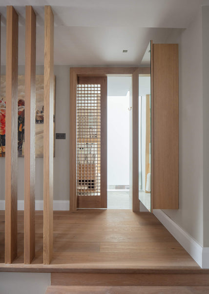 European oak wall cabinetry, trim, and pocket door finished with a single-layer hardwax oil wood stain and finish.