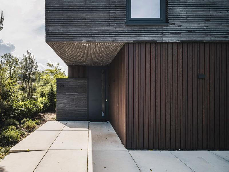 Vertical thermoash wood protected with DuroGrit exterior wood stain and finish in the color Bison Brown.