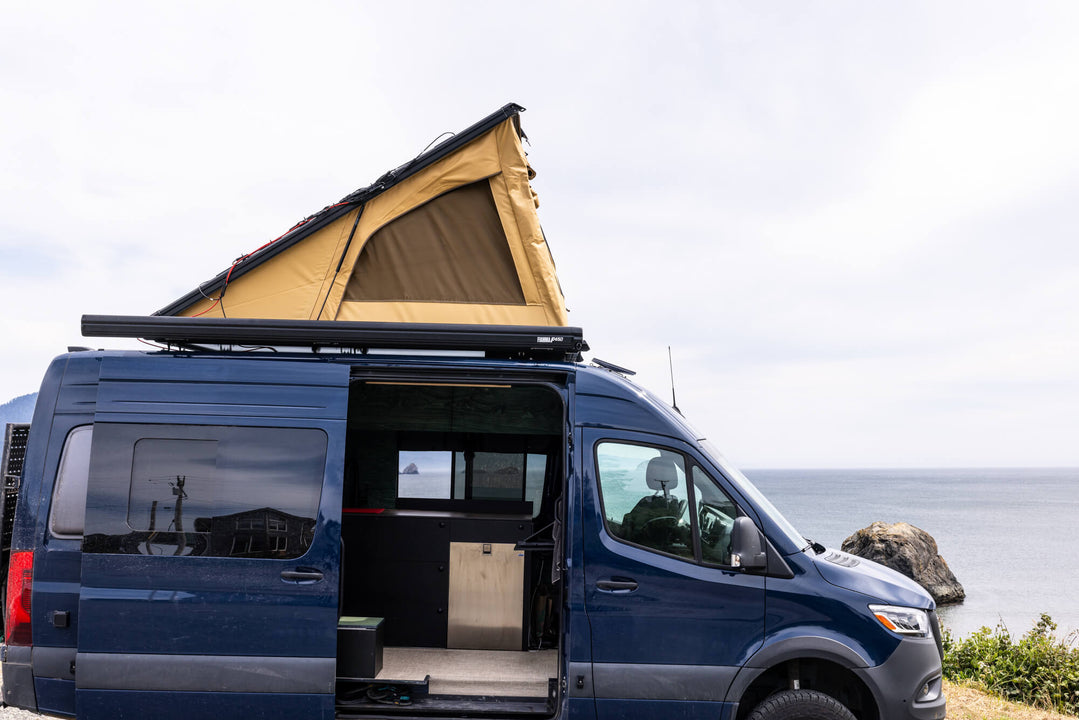 A custom sprinter van with the upper tent canopy raised.