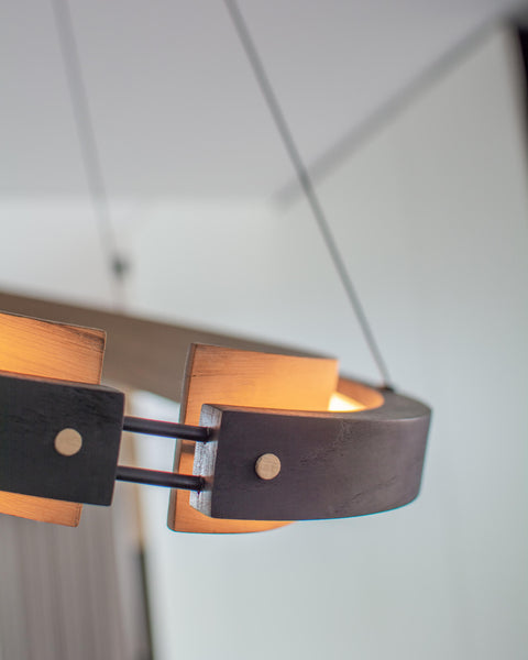 Details on a wood hanging light fixture finished with multiple Rubio Monocoat products. 