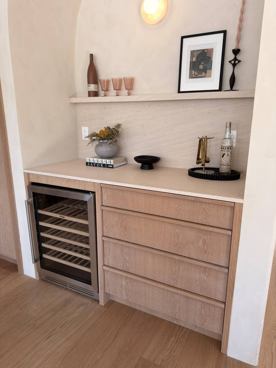 White oak bar cabinetry in Rubio Monocoat Oil Plus 2C Natural, featuring integrated wine fridge, soft-close drawers, and a floating stone shelf.