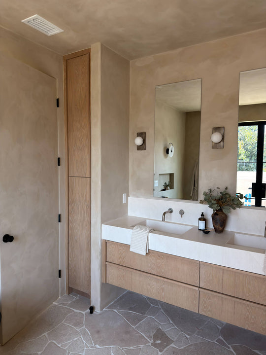 White oak double vanity and matching tall cabinet finished in Rubio Monocoat Oil Plus 2C Natural.