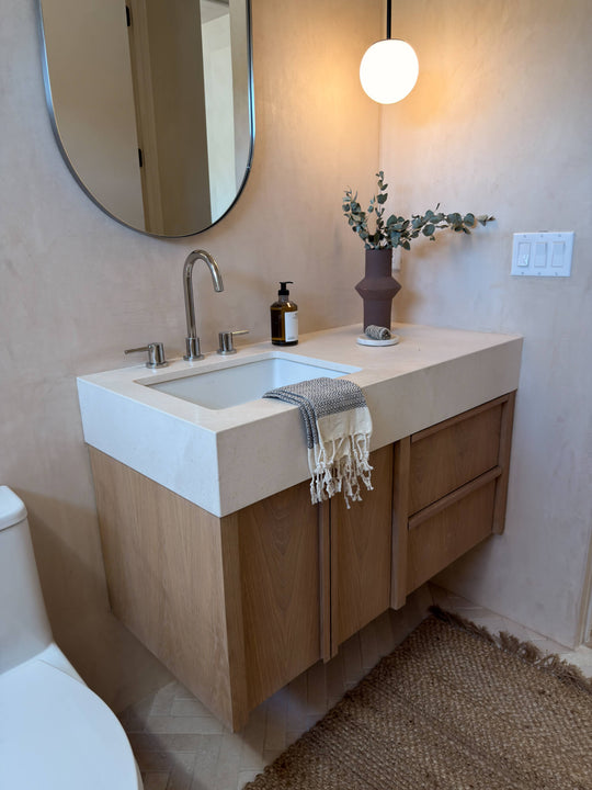 Modern white oak bathroom vanity with integrated sink, finished in Rubio Monocoat Oil Plus 2C Natural.