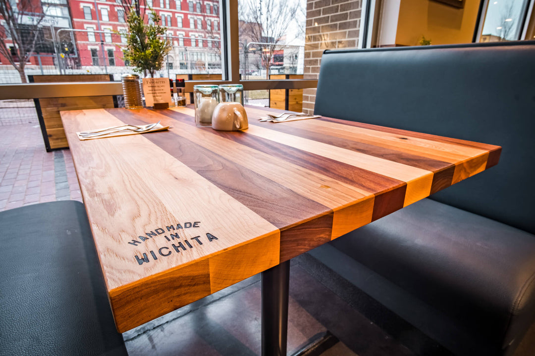 A restaurant table made from several different wood species and finished with Rubio Monocoat Oil Plus 2C hardwax oil wood stain and finish for interior wood projects.