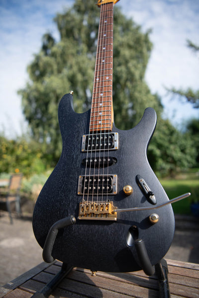 A mahogany Ibanez guitar was refinished with Rubio Monocoat Precolor Easy Intense Black and Oil Plus 2C Midnight Sky for a sleek look with a blue leaning hue. 