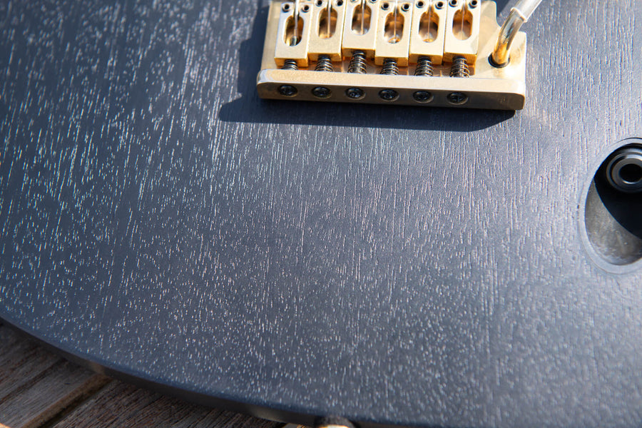 Mahogany wood grain on a recently refinish Ibanez guitar with a blueish black wood stain and finish from Rubio Monocoat.