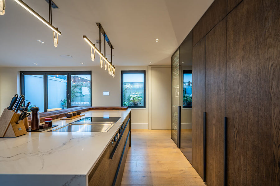 A lavish penthouse kitchen with full-length paneled oak cabinet doors. 