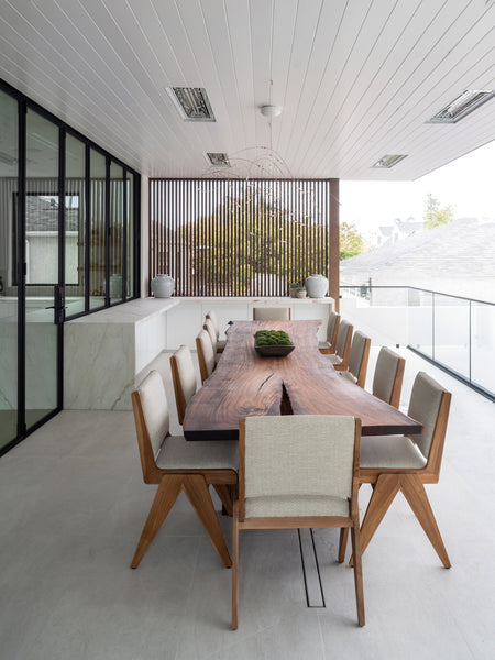 An enormous dining table made from exotic wood finished using a clear hardwax oil wood finish. 