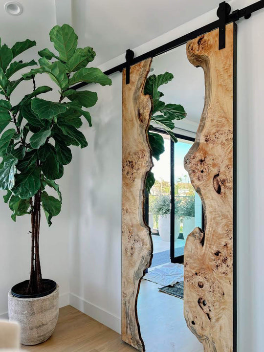 Stunning mappa burl slabs holding a mirror that is also a sliding door. The wood is finished with Oil Plus 2C hardwax oil wood finish for interior use.