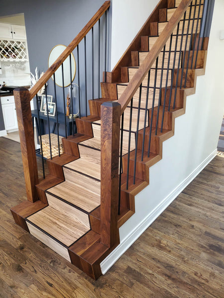 A custom wood staircase crafted from a variety of wood species including black walnut, zebra wood and wenge.