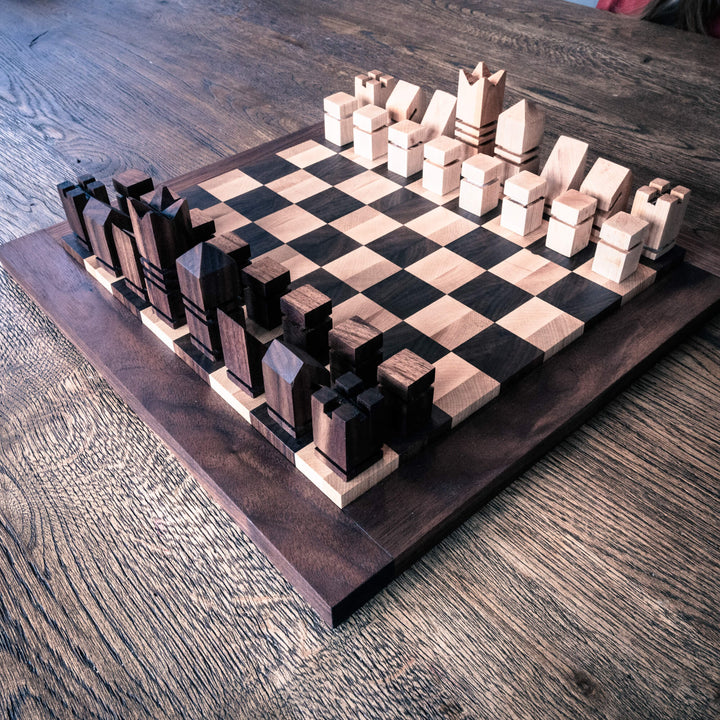 A modern chess board and chess pieces made from walnut and maple wood and finished with a hardwax oil wood finish.