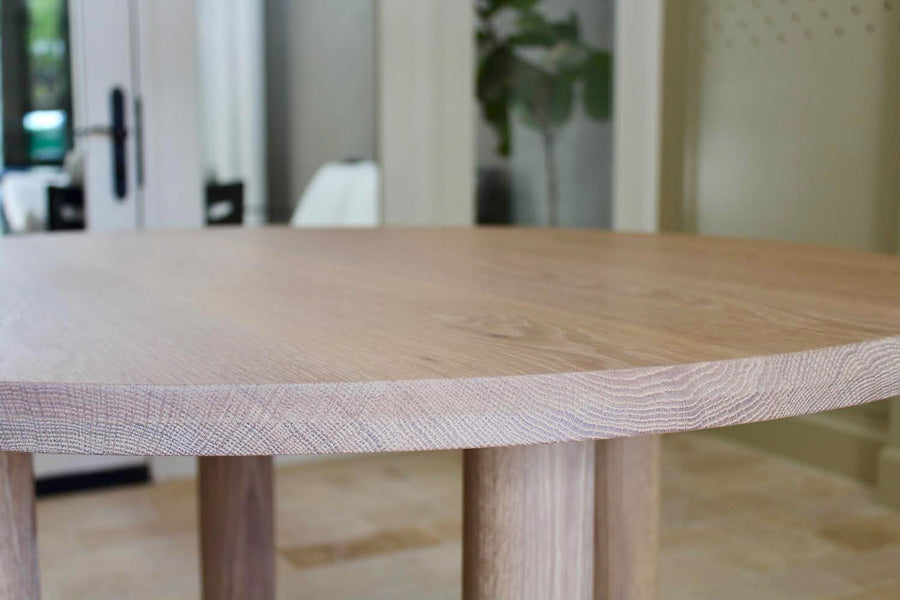 Close up of the top of a round white oak table finished with Rubio Monocoat Oil Plus 2C.