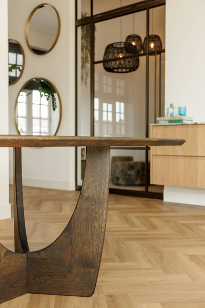 Detail shot of an oak dining table with a unique base finished with a single layer wood stain and sealer. 