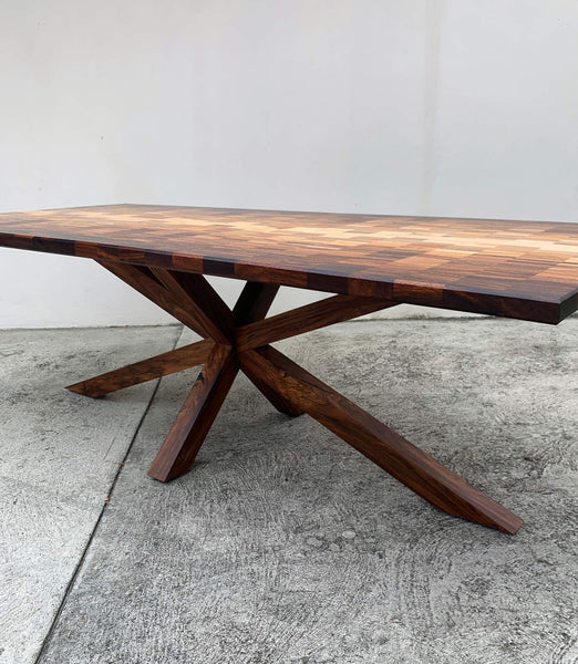 A unique dining table with a spider-like base finished with Rubio Monocoat Oil Plus 2C.