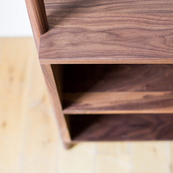Shelving in an open walnut wardrobe.