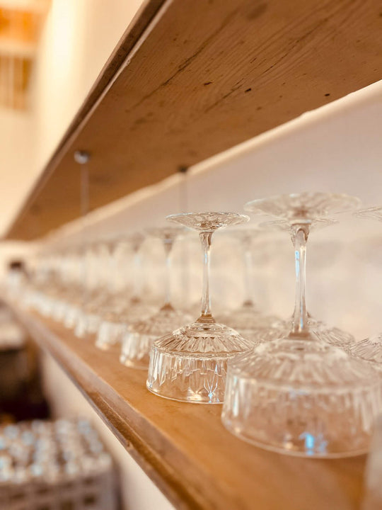 Wood shelves finished using Rubio Monocoat hardwax oil wood finish holding glass cups.