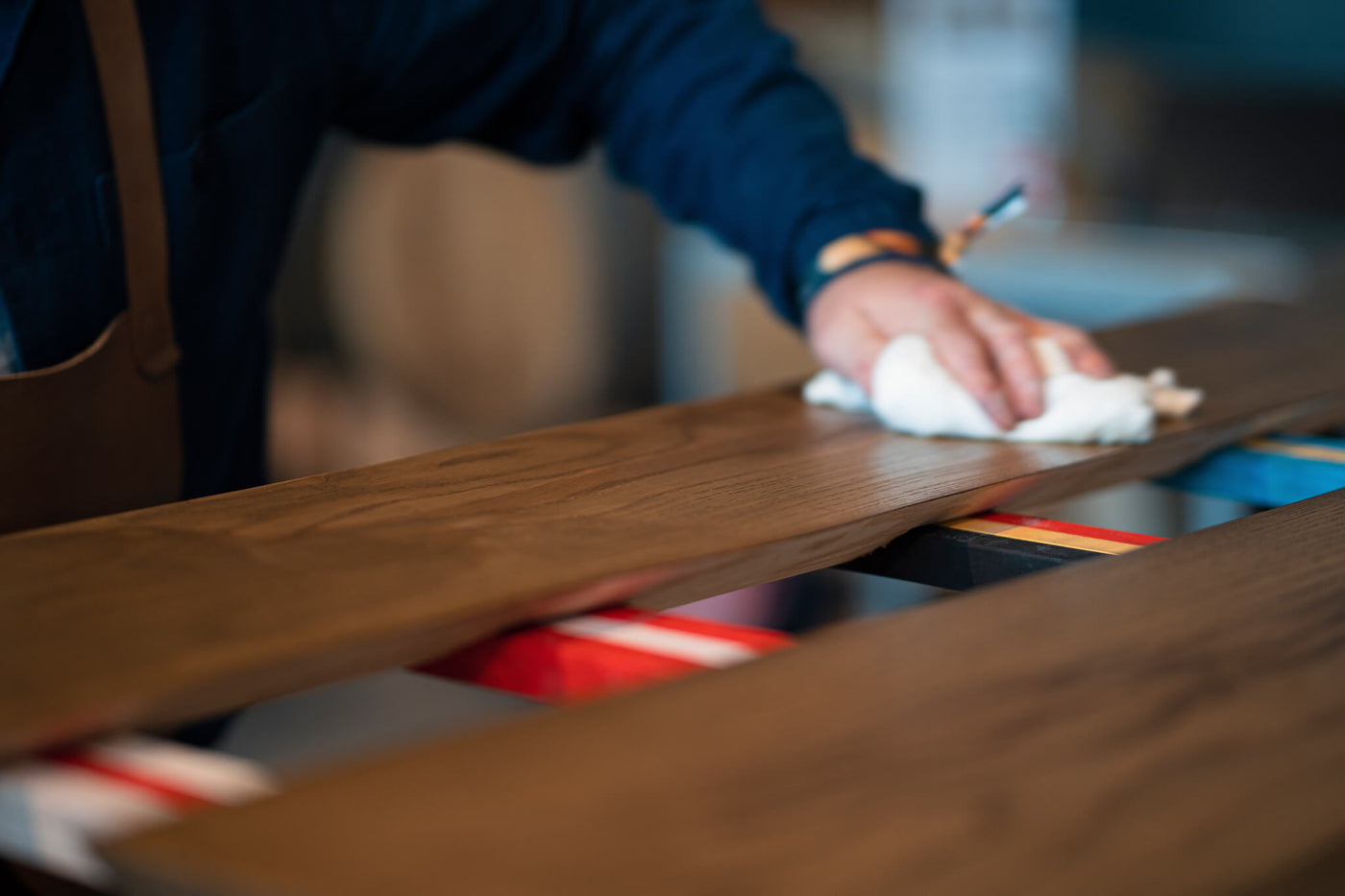 Person applying wood stain and finish at the Rubio Monocoat build off and philanthromake event