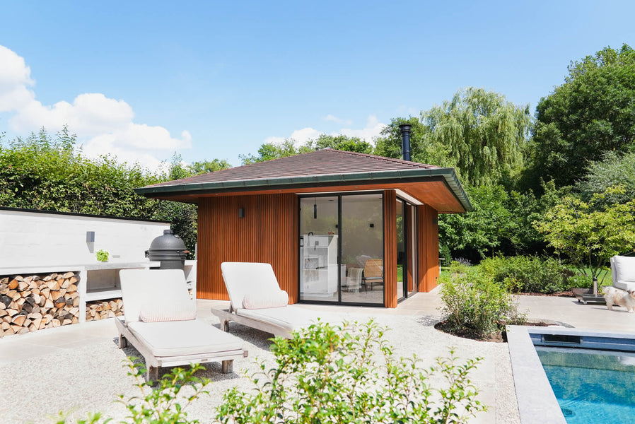 A poolhouse with Thermo Ayous cladding finished in a warm brown exterior wood finish called DuroGrit.