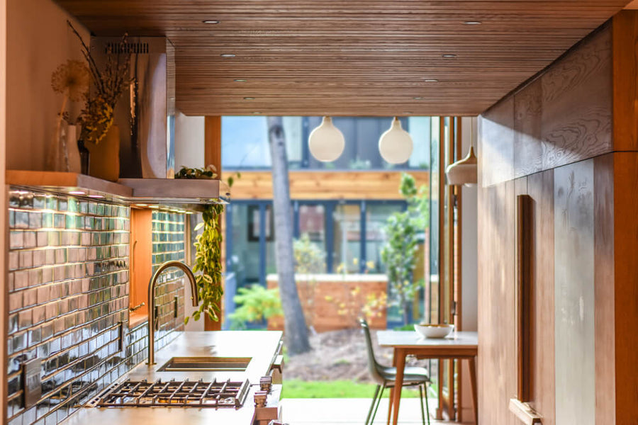 A view of a galley kitchen looking out to the outside of a property.