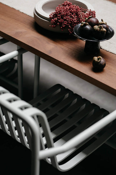 A close up of an exterior dining table and chair protected with Rubio Monocoat Hybrid Wood Protector