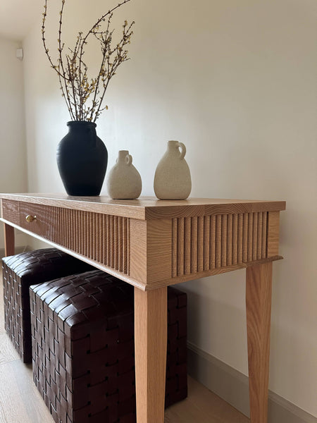 Side angled view of a reeded red oak console table finished with Rubio Monocoat Oil Plus 2C hardwax oil wood finish.