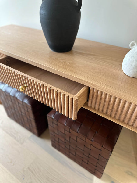 The center drawer of a reeded red oak console table slighty ajar. The table was finished using Rubio Monocoat hardwax oil wood finish in the color "White 5%".