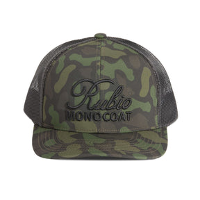 Camouflage cap with Rubic Monocoat logo on a white background