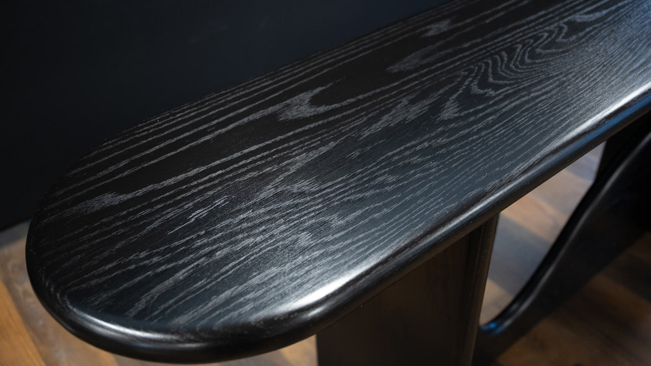 The pill shaped top of a modern console table made from white oak and finished with Rubio Monocoat products.