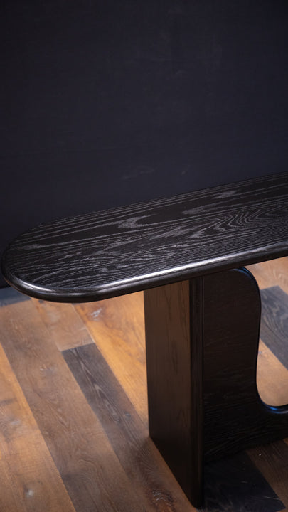 A modern console table crafted from white oak featuring rounded over edge and soft, sweeping curves.