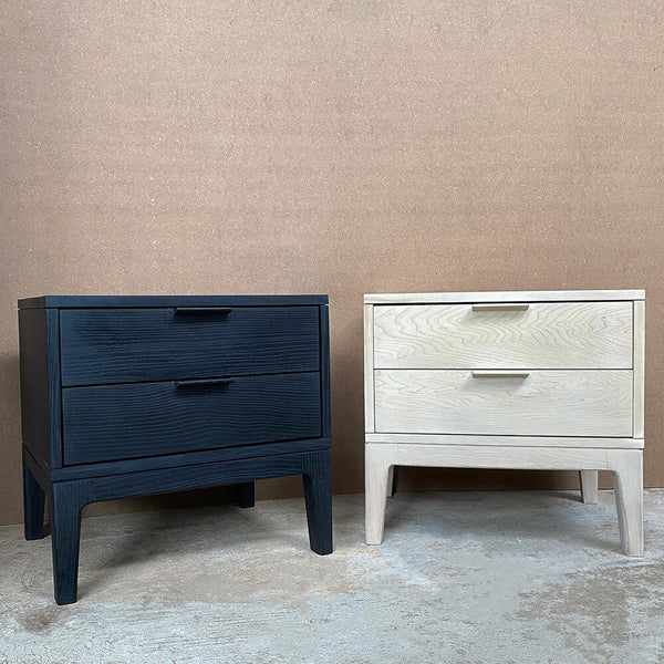 Two side tables, one black, one white, sitting side by side