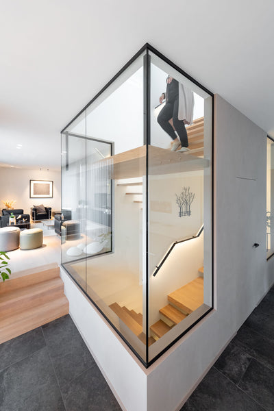 A two-level staircase made from european oak with someone walking down it.