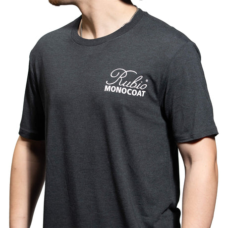 Person wearing a dark gray t-shirt with 'Rubio Monocoat' logo on a white background
