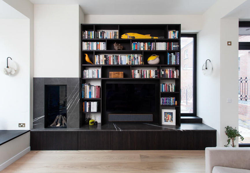 Wood built-ins finished in a very dark brown with a fireplace and marble stone surround.
