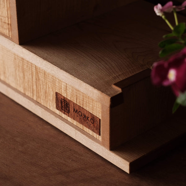 Wood maker branding on the side of a custom, handmade wooden tea cabinet finished with a durable hardwax oil.