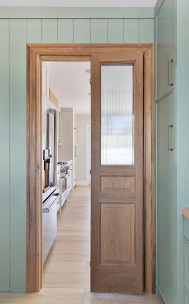 White oak pantry doors, one open. The pair of doors are finished with a hardwax oil wood finish. 