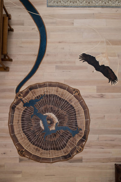 Tree ring wood floor inlay and an eagle wood floor inlay.