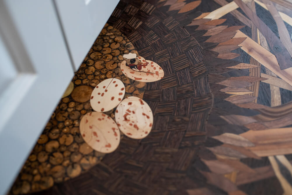 Osprey eggs wood floor inlay.
