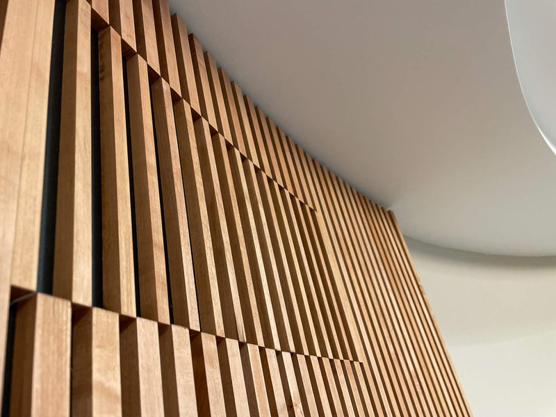 Curvature and details of a maple wood slatted door.