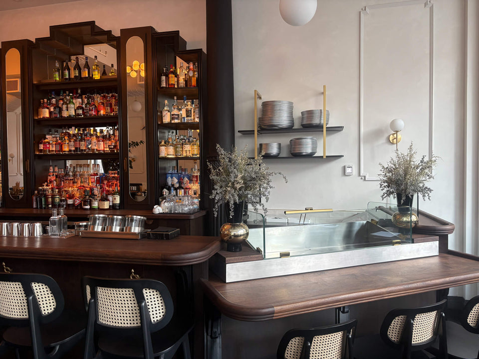 A high-end seafood restaurant with a 50' long walnut bar top finished with Rubio Monocoat Oil Plus 2C hardwax oil wood stain and finish.