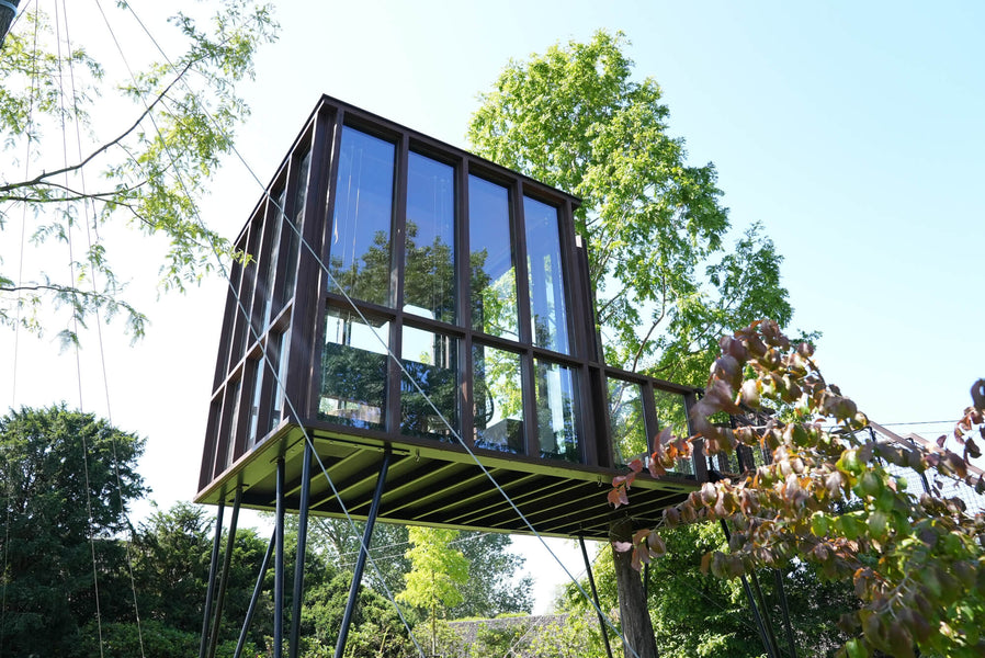 A modern tree house made from wood and many windows finished using Rubio Monocoat DuroGrit. 