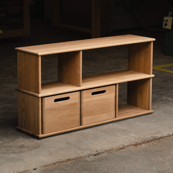 Three-quarter view of a white oak modular shelving unit with two storage cubes on the bottom shelf, finished in Rubio Monocoat Oil Plus 2C Dunes.