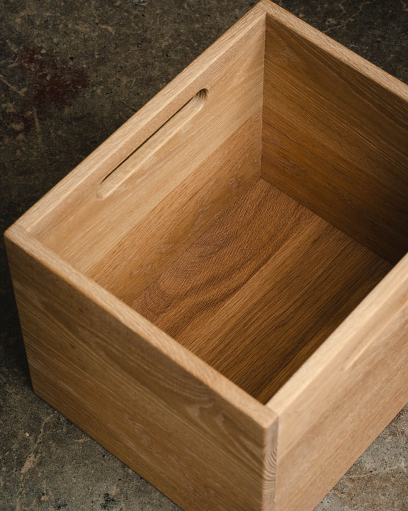 Top-down interior view of a white oak storage cube bin showing cutout handle detail and natural wood grain, finished with Rubio Monocoat Dunes.