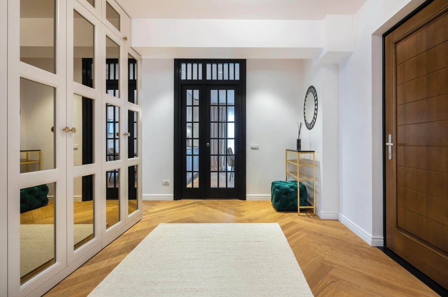 Herringbone wood floors in large entryway.