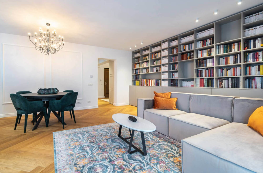 Living room with natural colored herrnigbone wood flooring.