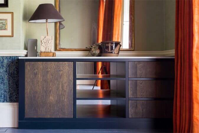 Modern vanity with cabinet and drawers made form metal and wood.