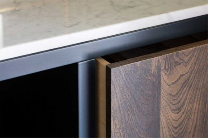 Detail shot of hardwood panel on front of vanity.