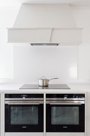 Modern and clean white shaker kitchen with two ovens.
